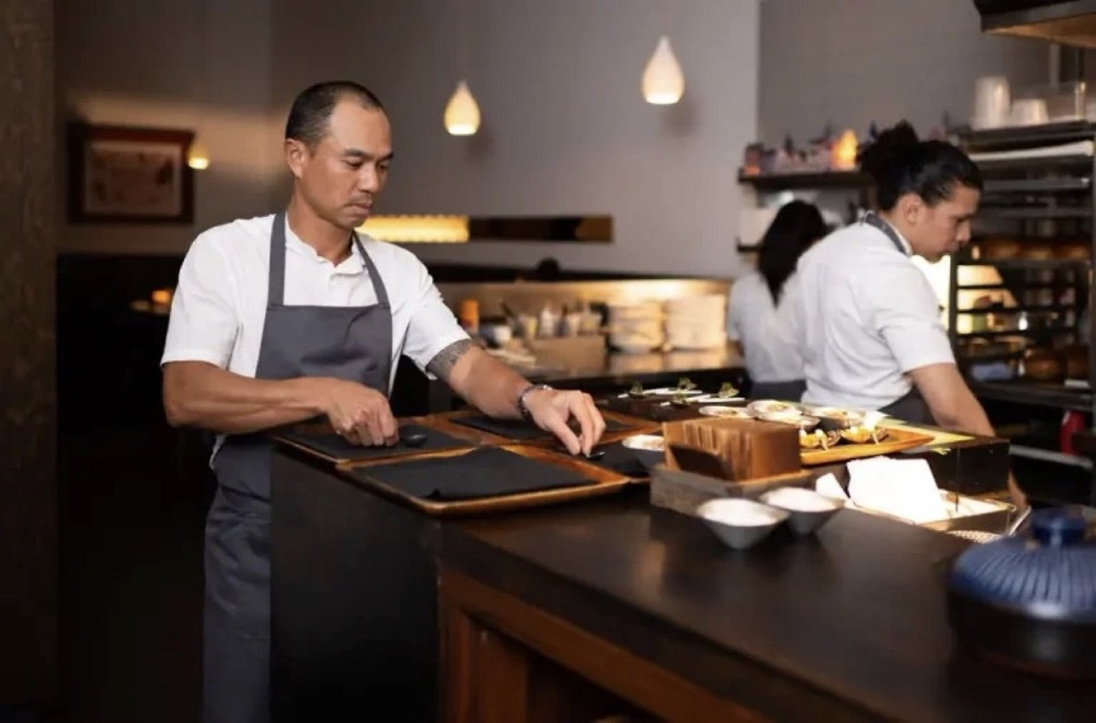 Commis — chefs plating at the pass
